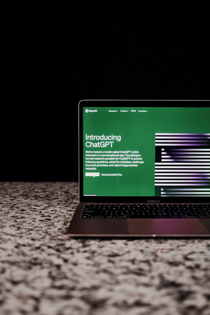 Laptop showing ChatGPT interface on a marble surface, showcasing AI technology.
